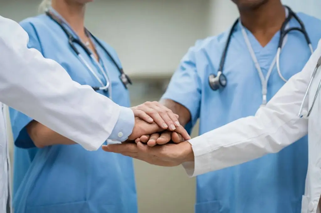 Close-up-of-doctors-and-nurses-stacking-their-hands-in-a-gesture-of-teamwork-and-collaboration.png